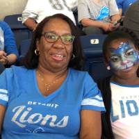 a girl with her face painted and a woman smiling